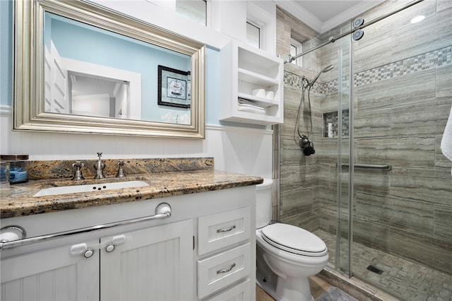 bathroom featuring toilet, an enclosed shower, and vanity