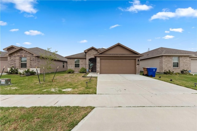 ranch-style home featuring a front yard, concrete driveway, brick siding, and an attached garage