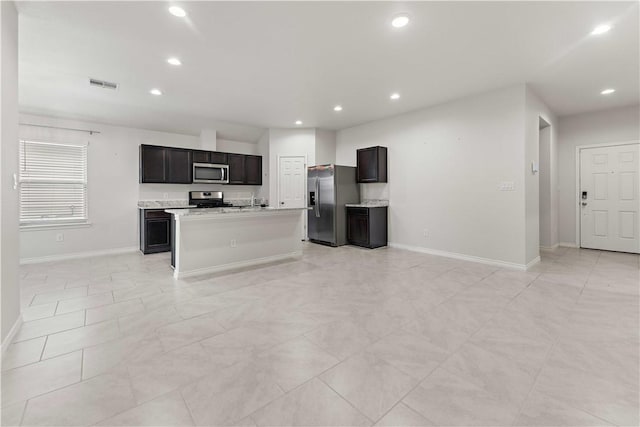 kitchen featuring recessed lighting, light countertops, visible vents, appliances with stainless steel finishes, and a kitchen island with sink