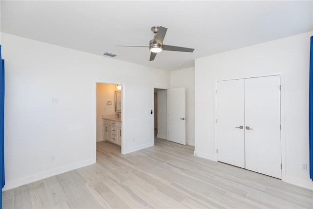 unfurnished bedroom featuring visible vents, baseboards, ceiling fan, light wood-style flooring, and a closet