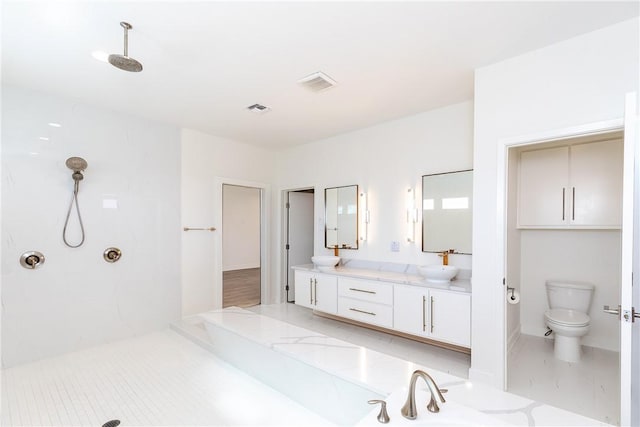 bathroom featuring visible vents, walk in shower, and a sink