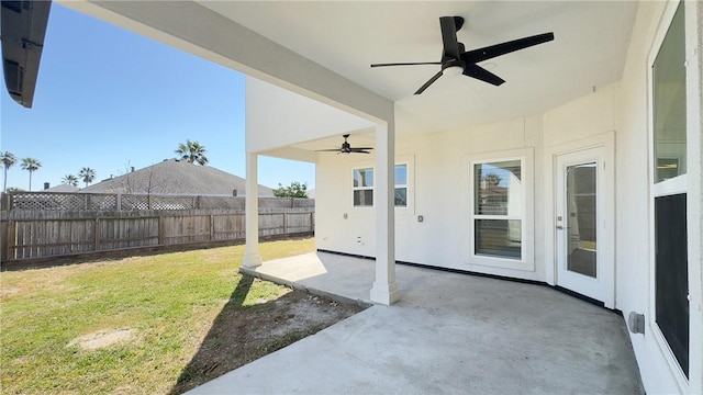 view of patio / terrace with a ceiling fan and fence