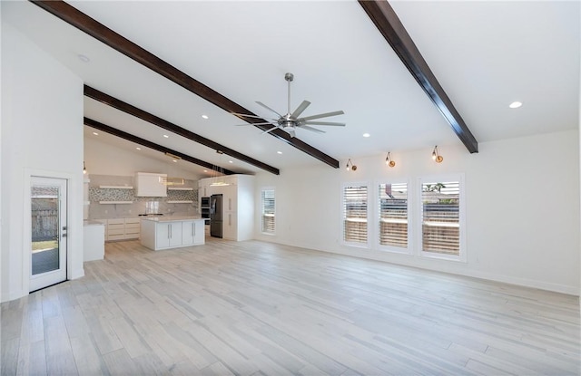 unfurnished living room featuring light wood finished floors, baseboards, ceiling fan, lofted ceiling with beams, and recessed lighting