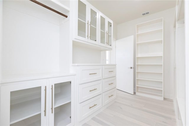 spacious closet with visible vents and light wood-type flooring