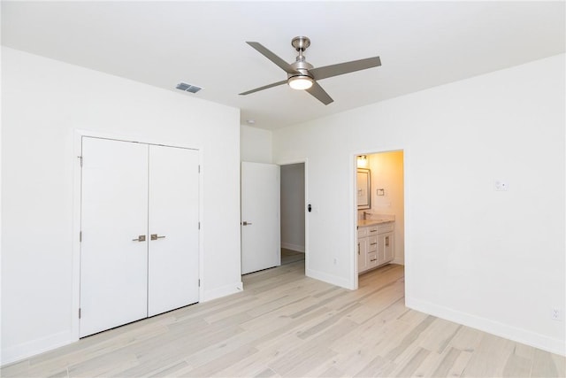 unfurnished bedroom featuring a ceiling fan, baseboards, visible vents, a closet, and light wood-type flooring