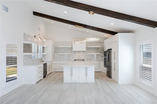 kitchen with open shelves, lofted ceiling with beams, tasteful backsplash, appliances with stainless steel finishes, and light countertops