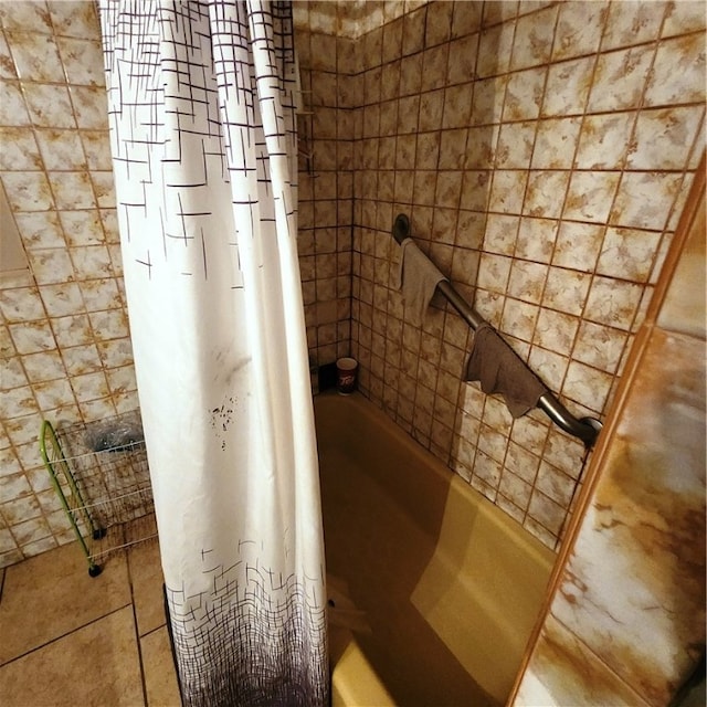 bathroom featuring tile patterned flooring and shower / bath combo