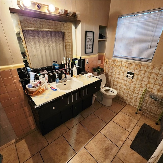 bathroom featuring tile walls, vanity, and toilet