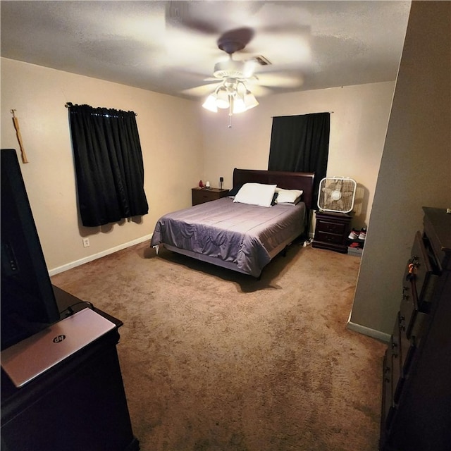 bedroom featuring ceiling fan and carpet