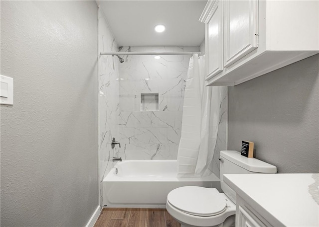 full bathroom with vanity, hardwood / wood-style floors, toilet, and shower / bath combo with shower curtain