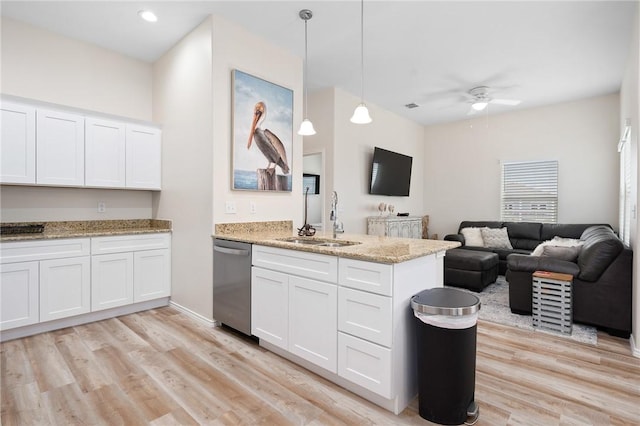 111 Great Chagos, Rockport, TX 78382 - kitchen with a sink, stainless steel dishwasher, a peninsula, open floor plan, and white cabinetry