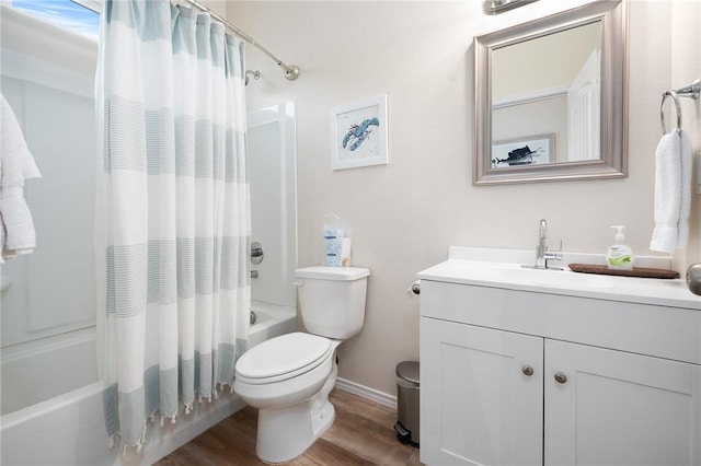 111 Great Chagos, Rockport, TX 78382 - bathroom featuring shower / bathtub combination with curtain, wood finished floors, toilet, vanity, and baseboards