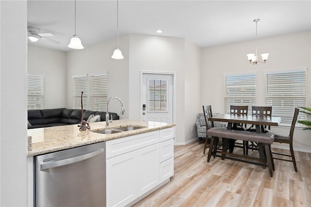 111 Great Chagos, Rockport, TX 78382 - kitchen with dishwasher, a sink, a ceiling fan, light stone countertops, and white cabinets