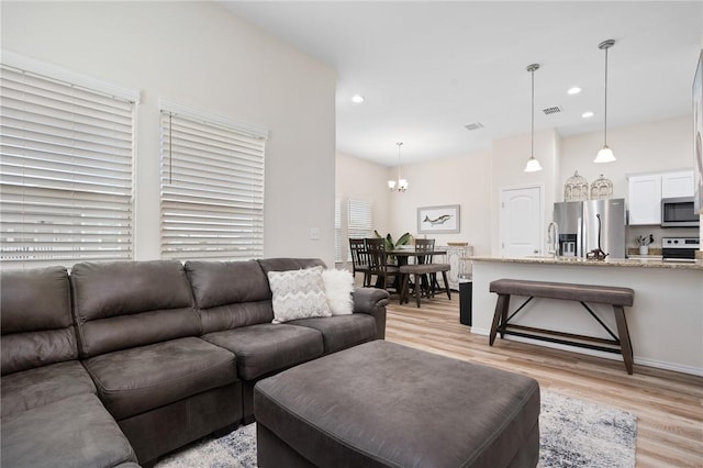 111 Great Chagos, Rockport, TX 78382 - living room with light wood-style floors, a chandelier, and recessed lighting