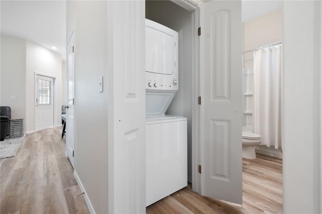 111 Great Chagos, Rockport, TX 78382 - laundry room with stacked washer / dryer and light wood finished floors