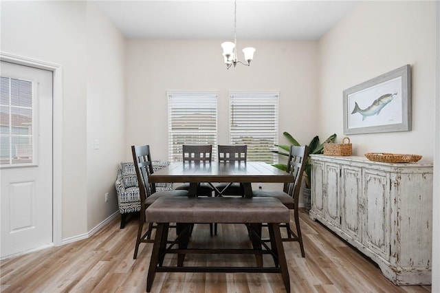 111 Great Chagos, Rockport, TX 78382 - dining area featuring a chandelier, light wood-style floors, and baseboards