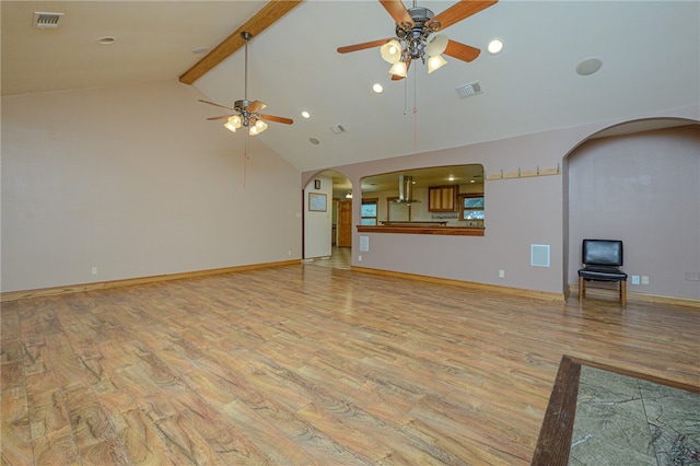 unfurnished living room featuring high vaulted ceiling, light wood-type flooring, ceiling fan, and beam ceiling