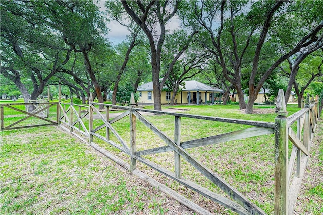 view of gate featuring a lawn