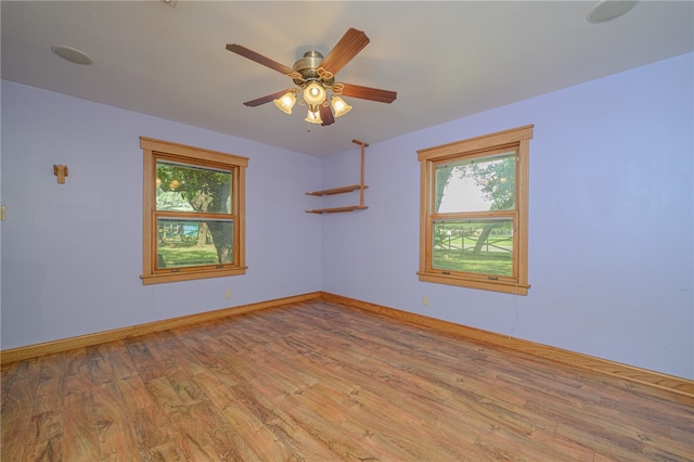 spare room featuring light wood-type flooring and ceiling fan