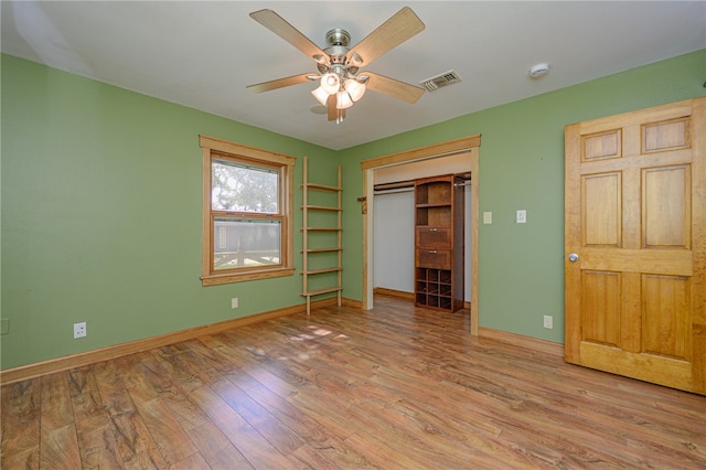 unfurnished bedroom with a closet, light wood-type flooring, and ceiling fan