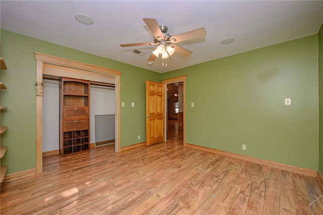 unfurnished bedroom with light hardwood / wood-style floors, ceiling fan, and a closet