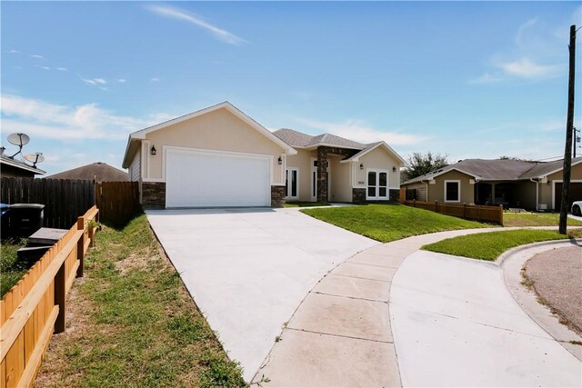 1530 Bay Moon Ct, Corpus Christi, TX 78417 - single story home featuring stone siding, driveway, an attached garage, and stucco siding