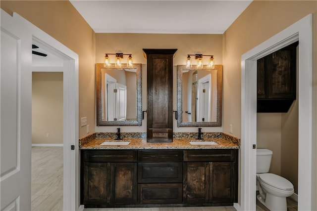 1530 Bay Moon Ct, Corpus Christi, TX 78417 - bathroom with double vanity, toilet, and baseboards