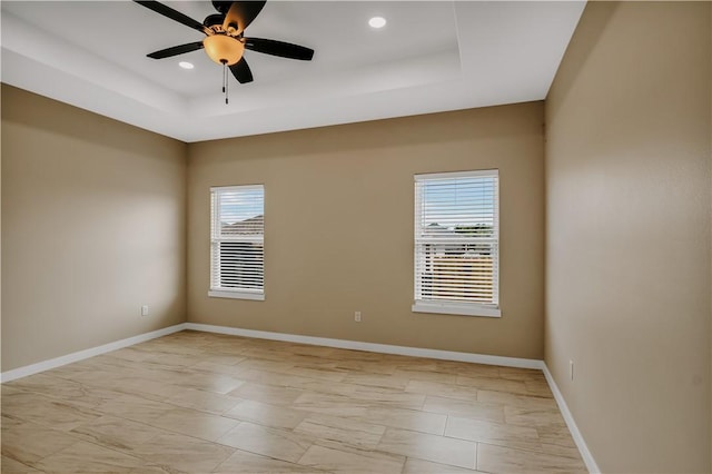 1530 Bay Moon Ct, Corpus Christi, TX 78417 - unfurnished room with a tray ceiling, plenty of natural light, light marble finish floors, and recessed lighting