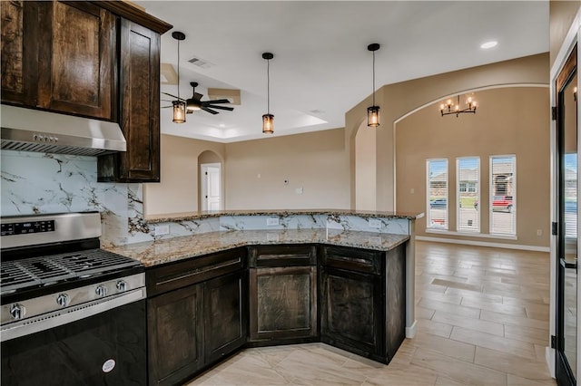 1530 Bay Moon Ct, Corpus Christi, TX 78417 - kitchen with gas range, under cabinet range hood, a peninsula, decorative backsplash, and arched walkways