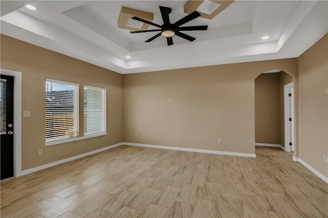 1530 Bay Moon Ct, Corpus Christi, TX 78417 - spare room featuring a raised ceiling, ceiling fan, arched walkways, recessed lighting, and baseboards