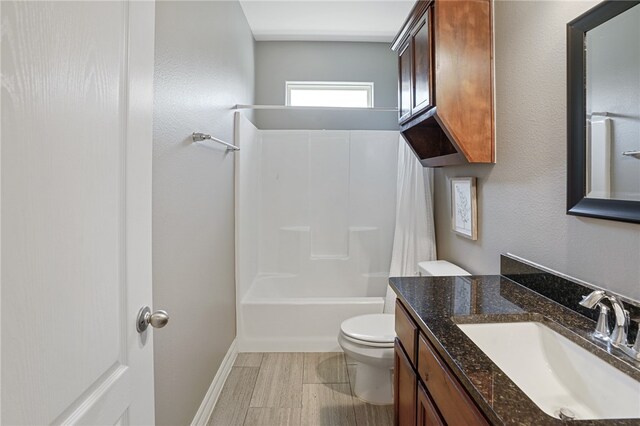 full bathroom with vanity, shower / tub combination, and toilet