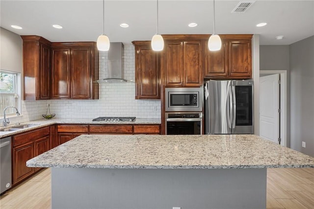 7618 Dove Hollow Dr, Corpus Christi, TX 78414 - kitchen featuring appliances with stainless steel finishes, wall chimney range hood, a sink, tasteful backsplash, and light stone countertops