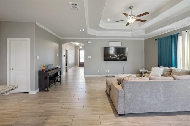 7618 Dove Hollow Dr, Corpus Christi, TX 78414 - living room featuring a ceiling fan, arched walkways, a raised ceiling, crown molding, and baseboards