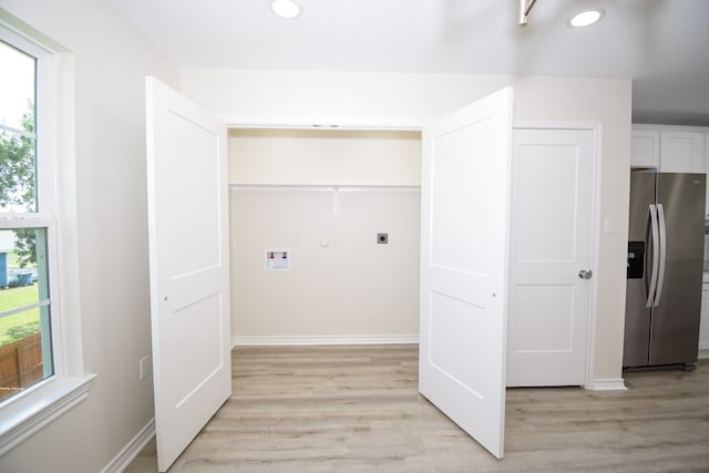 laundry area with light hardwood / wood-style floors, electric dryer hookup, and hookup for a washing machine