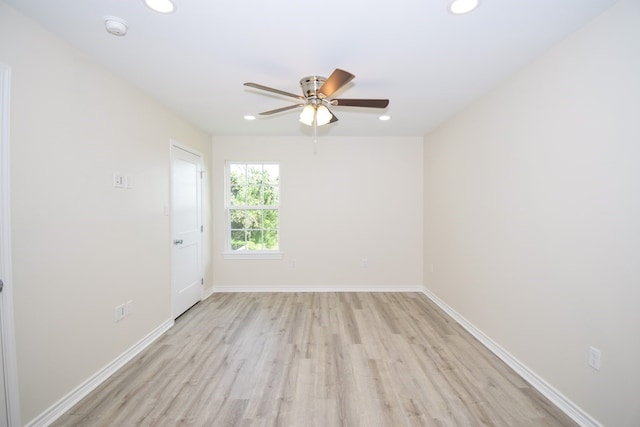 spare room featuring light hardwood / wood-style floors and ceiling fan