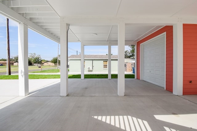 view of patio featuring a garage and a carport