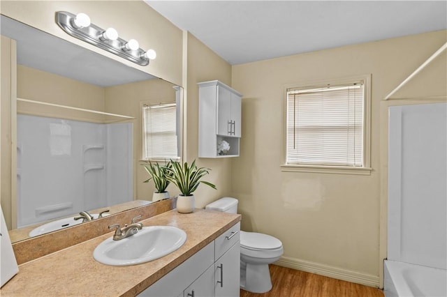 857 Belmeade Dr, Corpus Christi, TX 78412 - bathroom featuring wood finished floors, toilet, vanity, and baseboards