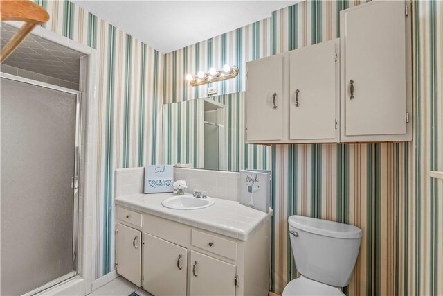 857 Belmeade Dr, Corpus Christi, TX 78412 - bathroom featuring a stall shower, vanity, toilet, and wallpapered walls