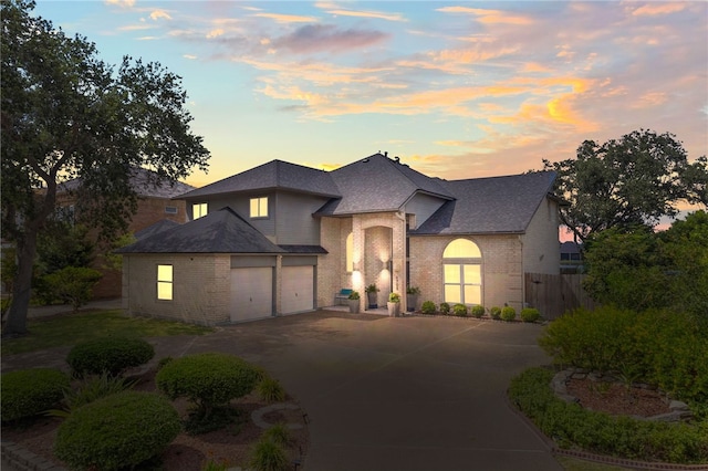 4705 Grand Lake Dr, Corpus Christi, TX 78413 - french country inspired facade with brick siding, concrete driveway, and a shingled roof
