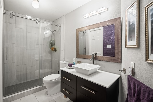 4705 Grand Lake Dr, Corpus Christi, TX 78413 - full bathroom with a shower stall, vanity, tile patterned floors, and a textured wall