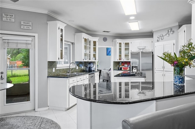 4705 Grand Lake Dr, Corpus Christi, TX 78413 - kitchen with appliances with stainless steel finishes, backsplash, white cabinets, glass insert cabinets, and ornamental molding