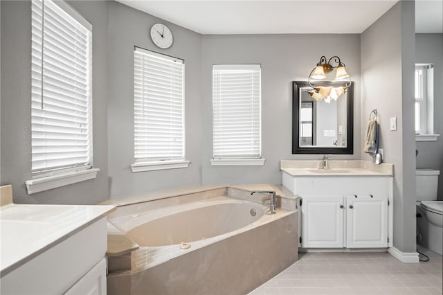4705 Grand Lake Dr, Corpus Christi, TX 78413 - bathroom featuring two vanities, plenty of natural light, and a tub with jets