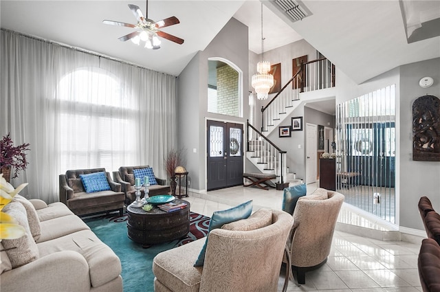 4705 Grand Lake Dr, Corpus Christi, TX 78413 - tiled living room featuring stairway, high vaulted ceiling, a chandelier, a ceiling fan, and french doors