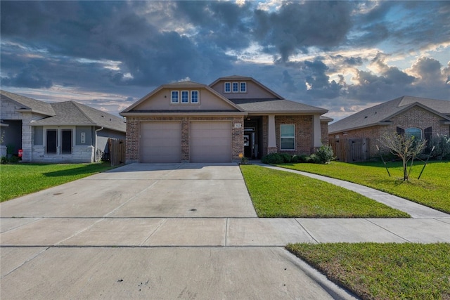 view of front of house featuring a garage and a lawn