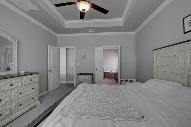 carpeted bedroom featuring decorative columns, a tray ceiling, ceiling fan, and crown molding