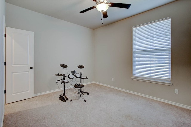 misc room featuring light colored carpet and ceiling fan