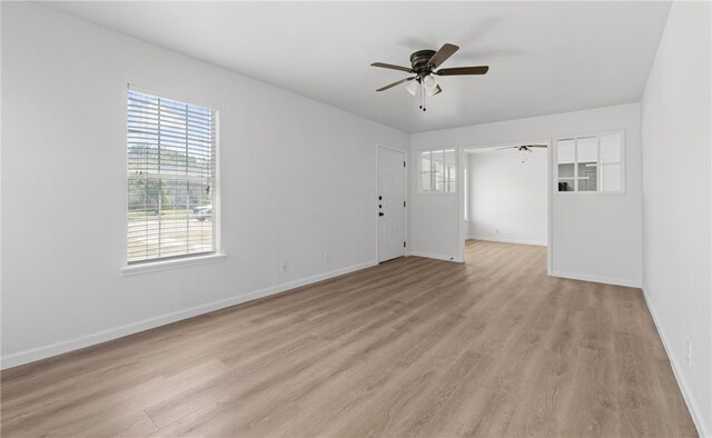 3618 Lawnview St, Corpus Christi, TX 78411 - empty room featuring a ceiling fan, light wood finished floors, healthy amount of natural light, and baseboards