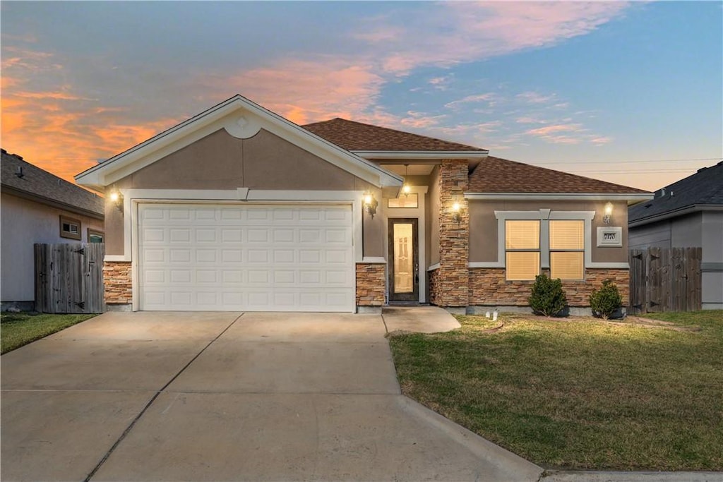 view of front of home featuring a lawn and a garage