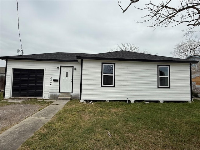 view of front of property featuring a garage and a front lawn