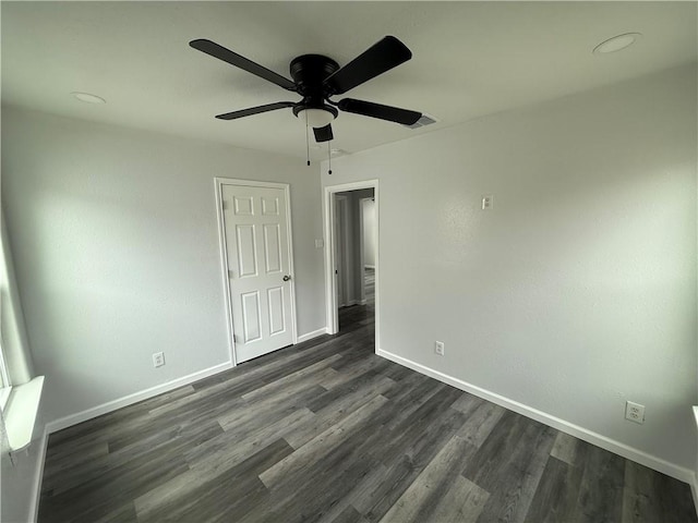 unfurnished bedroom featuring ceiling fan and dark hardwood / wood-style floors